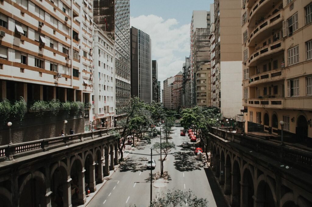 View of a vibrant city street flanked by skyscrapers and vintage architecture.