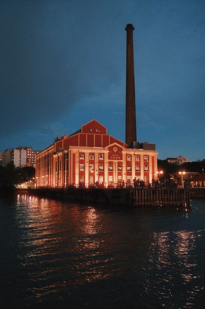 Capturing the illuminated Usina do Gasômetro by the waterfront at night in Porto Alegre, Brazil.